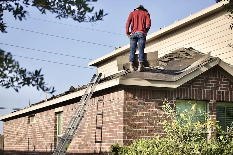 Professional roofer working on a residential roof in Ortega